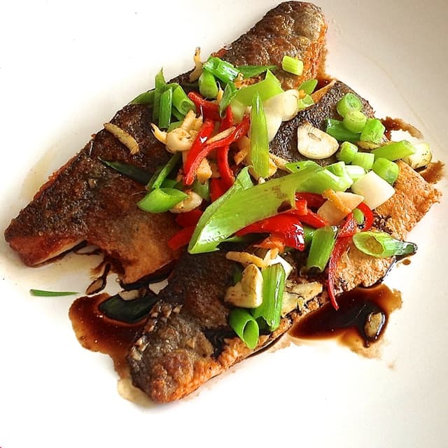 Sea bass with sizzled ginger, chilli & spring onions